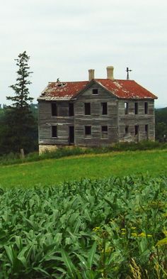 an old house in the middle of a field