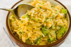 a bowl filled with pasta and broccoli on top of a table