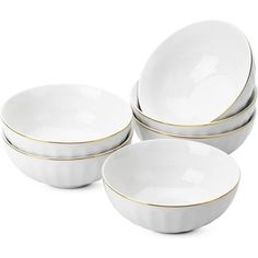 four white bowls with gold rims