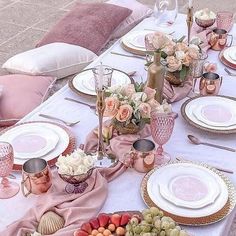 the table is set with pink and white plates