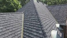 the roof of a house with many different types of shingles on it and trees in the background