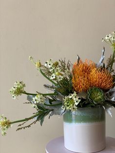 a white and green cake with flowers on top