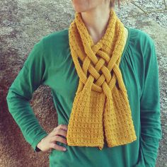 a woman wearing a yellow knitted scarf