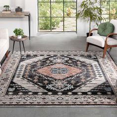 a living room area with two chairs and a rug on the floor in front of a window