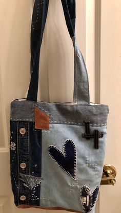 a handbag made out of old jeans is hanging on the door