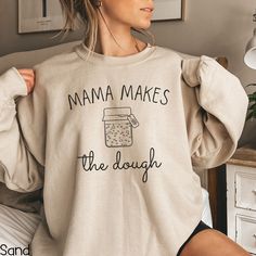 Embrace the warmth of homemade bread and the joy of baking with our 'Mama Makes the Sourdough Bread' sweatshirt. This funny crewneck celebrates the art of sourdough starters and the love baked into every loaf. Whether you're a seasoned baker or just getting started, this sweatshirt is a delightful addition to your wardrobe. Treat yourself or surprise a baking-loving mom with this thoughtful gift! IMPORTANT INFORMATION - All Sales Are Final: refunds, returns, or exchanges are not available since Super Soft Fleece Sweatshirt With Relaxed Fit, Super Soft Relaxed Fit Fleece Sweatshirt, Relaxed Fit Fleece Sweatshirt, Super Soft, Super Soft Cozy Fit Crew Neck Sweatshirt, Super Soft Crew Neck Cotton Sweatshirt, Super Soft Cotton Crew Neck Sweatshirt, Homemaker Gifts, Sourdough Starters, Baker Shirts