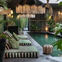 an indoor swimming pool with green and white striped furniture