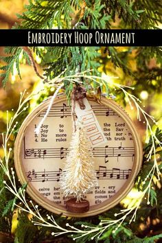 an ornament hanging from a tree with music notes on it and the words embroidery hoop