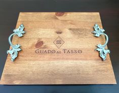 a wooden cutting board with the words guadalajara tasso engraved on it's side