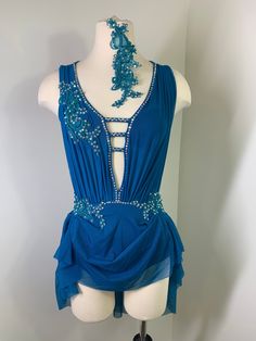 a mannequin wearing a blue dress with beading on it