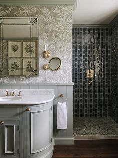 a bathroom with a sink, mirror and shower in it's center piece is shown