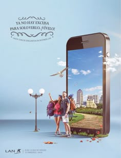 two people standing in front of a cell phone with an image of a city on the screen