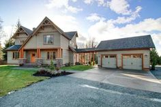 a large house with two garages in front of it