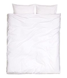 a bed with white sheets and pillows on top of it, against a white background