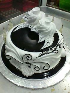 a white and black cake sitting on top of a table