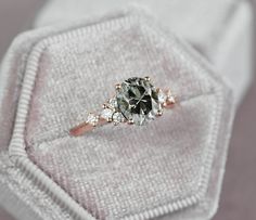 a diamond ring sitting on top of a white cloth