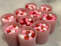 small cups filled with hearts on top of a table next to a white countertop