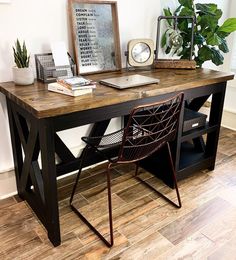 a desk with a chair and a clock on it next to a potted plant