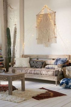 a living room filled with lots of furniture next to a wall mounted hanging planter