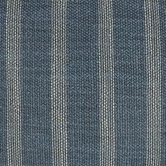 a blue and white striped rug with vertical stripes on the bottom, in an area that looks like it has been made out of wool