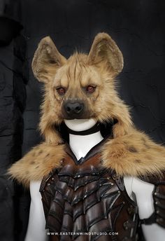 a stuffed animal wearing a leather armor and fur collar