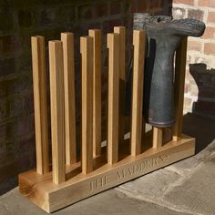 a wooden stand with a hammer and some sort of tool on it