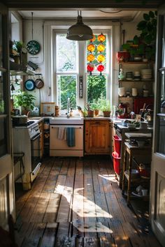 a kitchen with wooden floors and lots of windows