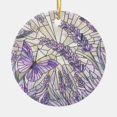 a round stained glass ornament with purple flowers and butterflies on the front, hanging from a gold chain