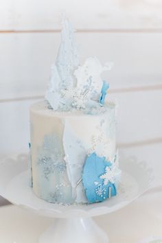 a white and blue cake sitting on top of a table