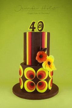 a multi - tiered cake decorated with flowers and the number forty