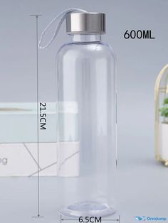 a clear glass water bottle with a metal lid and spigot on the side