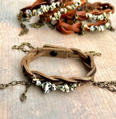 "Fun and funky braided real leather bracelet, wire~wrapped with beautiful Dalmatian Jasper beads. Chain details add a special kick to the style of this piece. These fit a variety of wrist sizes, especially since leather can stretch with wear (or add a tad bit of water to the leather and GENTLY stretch). Button closure. I love to wear mine stacked with other pieces, as shown! Please check out my other listings for all sorts of \"stacking\" options:) **This listing is for ONE bracelet as described above** **Color of leather and pattern on gemstones will vary due to the natural state of each**" Boho Leather Bracelet, Dalmatian Jasper, Beads Chain, Wire Wrapped Bracelet, Bracelet Leather, Boho Leather, Jasper Beads, Braided Leather, Leather Jewelry