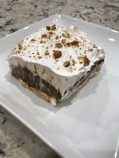 a piece of cake sitting on top of a white plate next to a marble counter