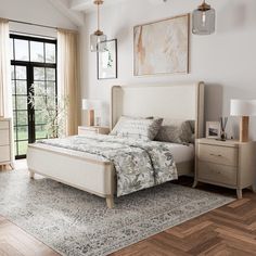 a bedroom with a bed, nightstands and windows