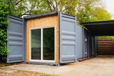 a couple of shipping containers sitting next to each other on top of a cement ground