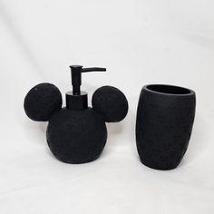 a mickey mouse soap dispenser and toothbrush holder on a white background