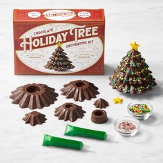 chocolate holiday tree decorating kit with candy and candies on the table next to it