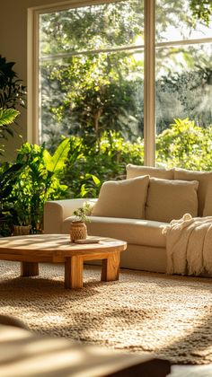 a living room filled with furniture and lots of plants in front of a large window