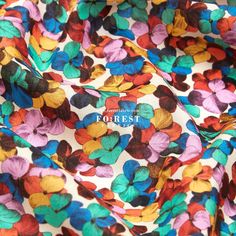 a colorful flower print fabric with the word forest printed on it's bottom corner