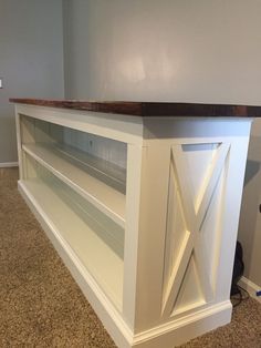 a white entertainment center with sliding doors and shelves