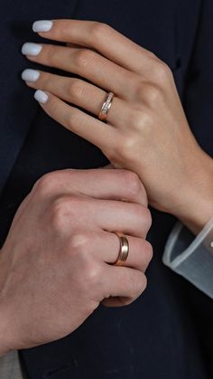 two people with wedding rings on their hands