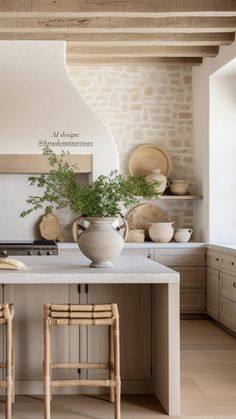 a kitchen with two stools and an island