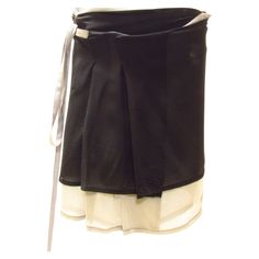 A delicate silk wrap mini skirt is black with a light grey layer beneath. It features a back pocket with flap and red stitching at back label. Black Mini Wrap Skirt With Lining, Yohji Yamamoto Street Style, Street Style Skirt, Black Wrap Skirt, Silk Wrap Skirt, Wrap Mini Skirt, Paneled Skirt, Fashion Sites, Silk Wrap