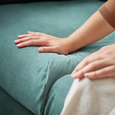 a woman's arm resting on the back of a couch