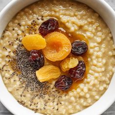 oatmeal with raisins and dried apricots in a white bowl