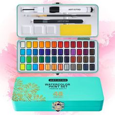 an artist's watercolor paint set in a blue box with pink background and gold foil