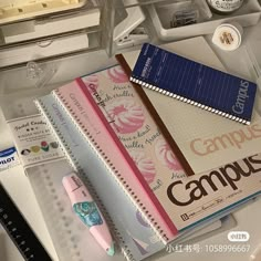 the contents of a school supply box are neatly organized, including notebooks and pens