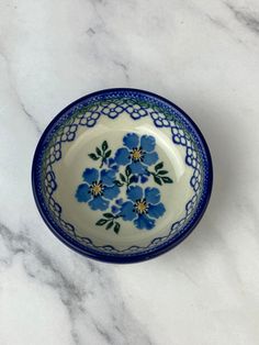 a blue and white bowl sitting on top of a marble counter