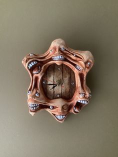 a clock made out of clay with teeth on it