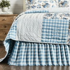 a blue and white checkered bedspread with ruffles on the bottom